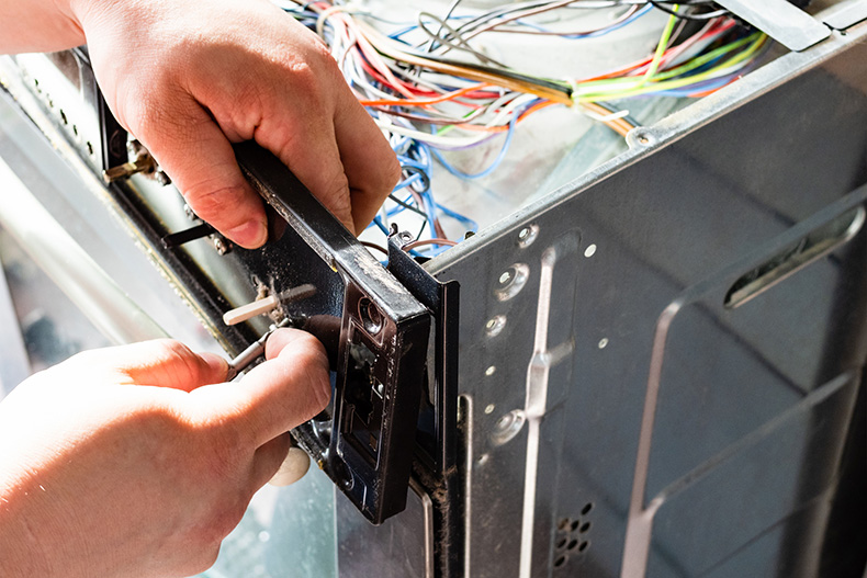 repairman fixes electric cooktop in colorado springs