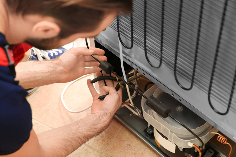 technician repairing a freezer